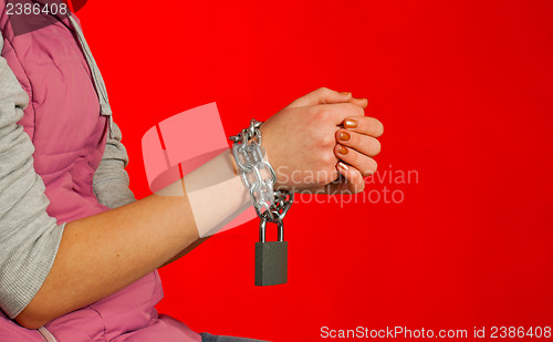 Image of Hands tied up with chains