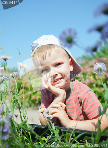 Image of Small boy laying on the grass