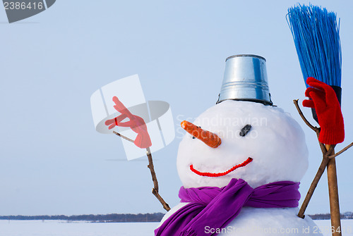 Image of Lonely snowman at a snowy field