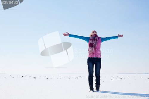 Image of Teen girl staying with raised hands
