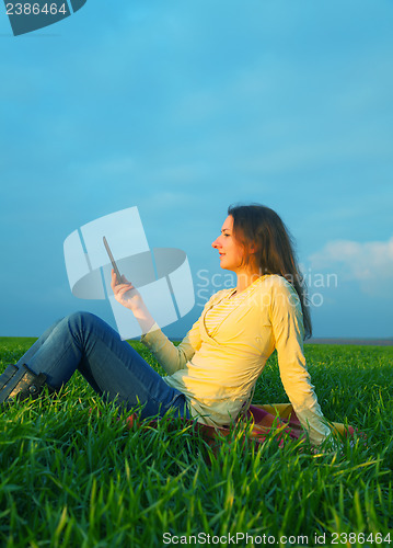 Image of Teen girl reading electronic book