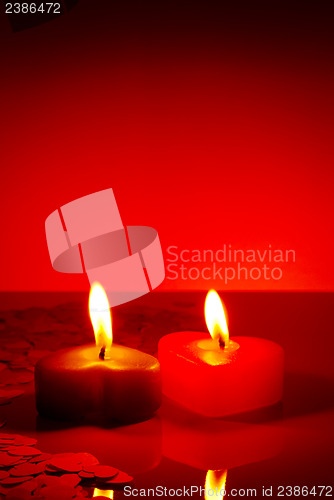 Image of Two burning heart shaped candles
