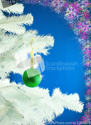 Image of Green ball hanging on the Christmas tree