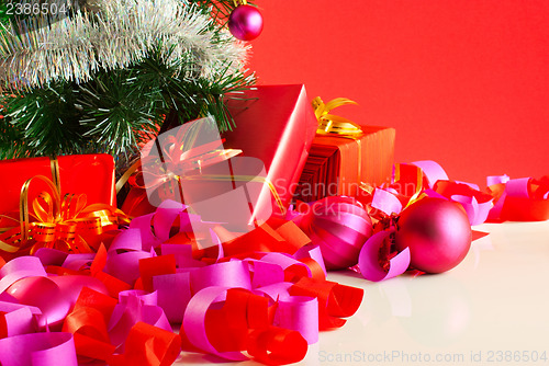 Image of Christmas gifts over red background