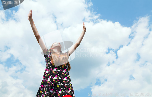 Image of Teen girl with raised hands