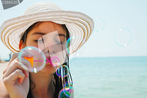 Image of Teen girl blowing bubbles