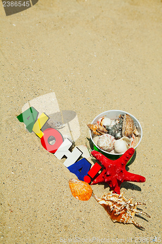 Image of Wooden colorful word 'Aloha' on the sand