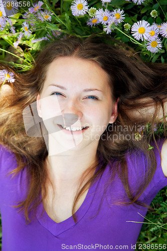 Image of Teen girl lying in grass