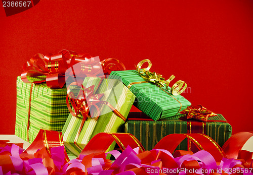 Image of Wrapped boxes with presents against red background