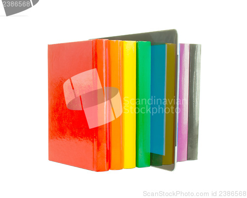 Image of Row of colorful books and electronic book reader over white back