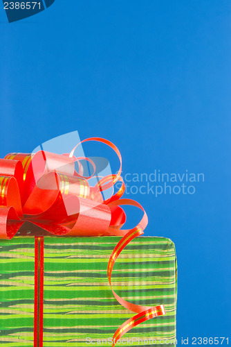 Image of Green box with present against blue background