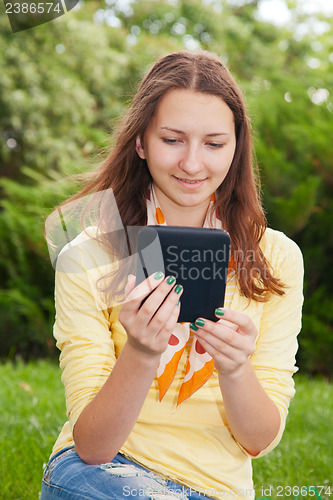 Image of Teen girl reading electronic book