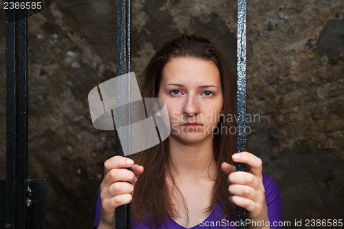 Image of Young woman behind the bars