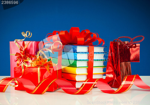 Image of Christmas presents with stack of books