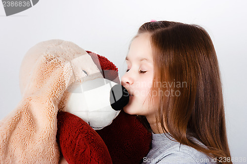 Image of teen girl kissing a toy dog