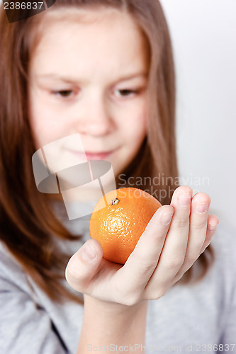 Image of teen holding in the palm of mandarin