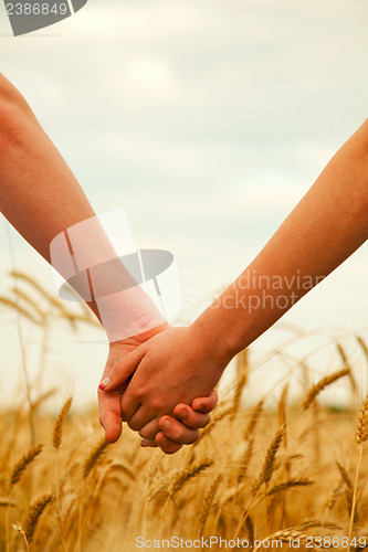 Image of Young couple holding hands 