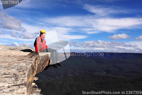 Image of Sitting on Top of the World - hiker rests and admires views of B