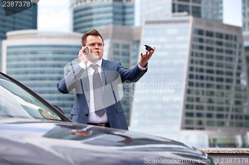 Image of Businessman near a car