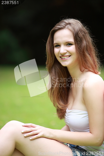 Image of Portrait of a pretty teenage girl in a lush park