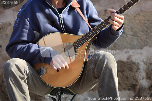 Image of Man playing a mandolin