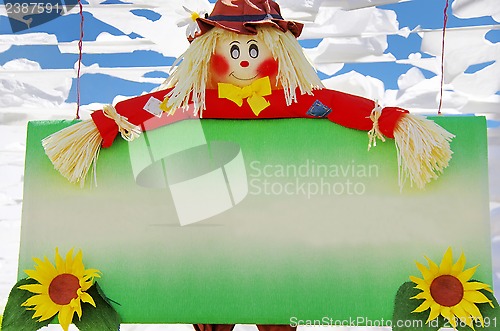 Image of Colorful scarecrow at garden 