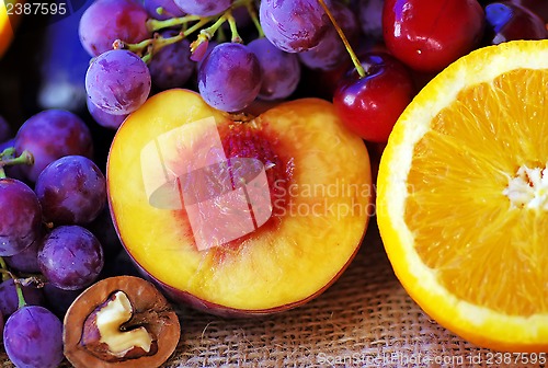 Image of Sliced peach and orange, fruits on table