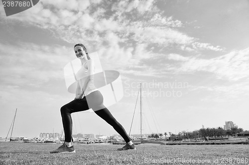 Image of Young beautiful  woman jogging  on morning