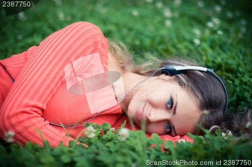 Image of Relaxed young woman listening music