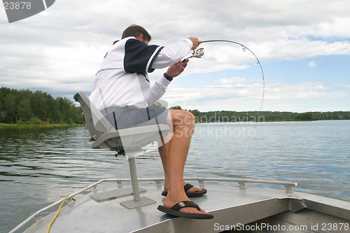Image of A man fishing from his boat.