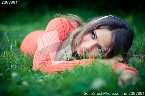 Image of Relaxed young woman listening music