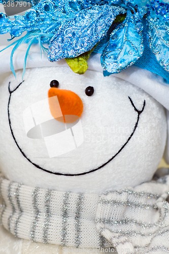 Image of Snow man toy with glamour scarf.