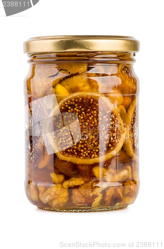 Image of Glass jar filled with honey, nuts and fruits