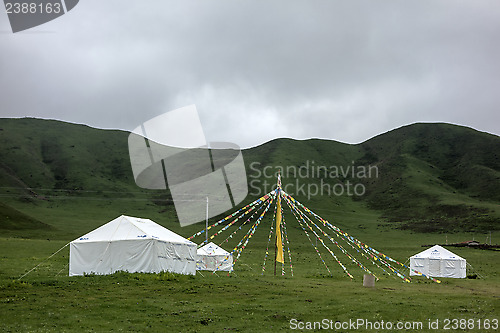 Image of Colorful buddhist flags and tents in the mountains