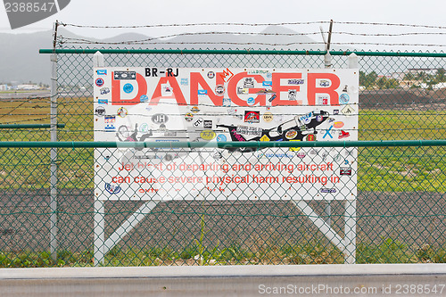 Image of PRINCESS JULIANA AIRPORT, ST MARTIN - JULY 19, 2013: Warning sig