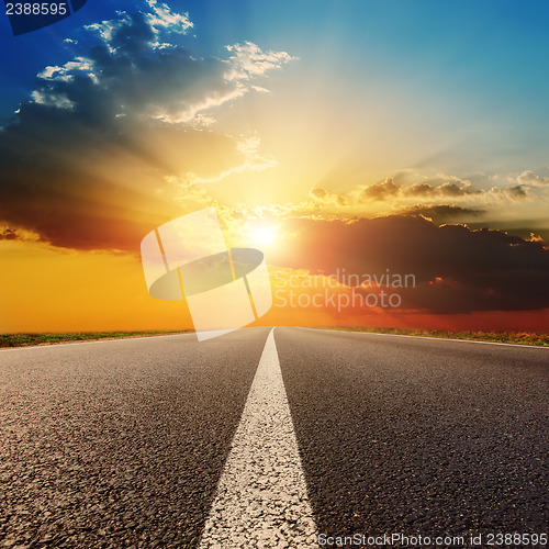 Image of asphalt road under sunset with clouds