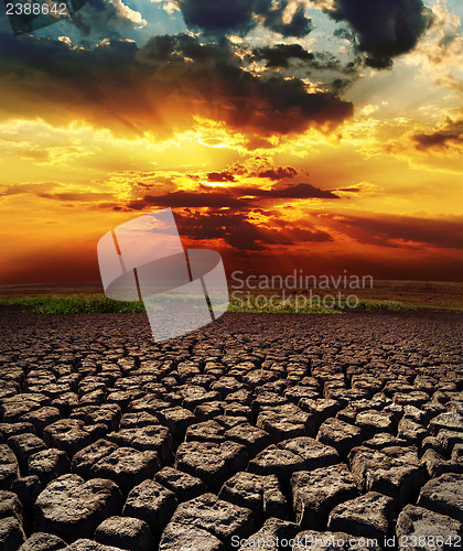 Image of dramatic sunset over drought land
