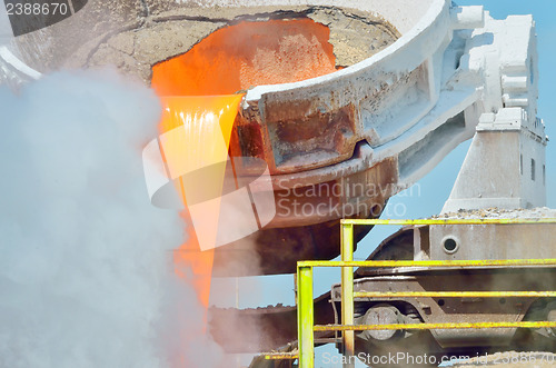 Image of The molten slag is poured from a cup 