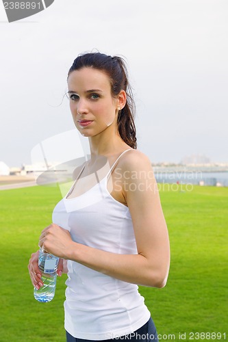 Image of Young beautiful woman drinking water after fitness exercise