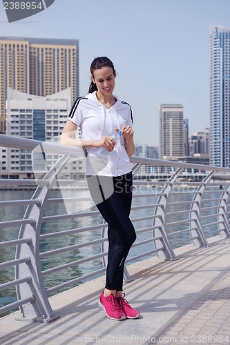 Image of Young beautiful  woman jogging  on morning