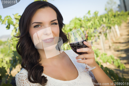 Image of Young Adult Woman Enjoying A Glass of Wine in Vineyard