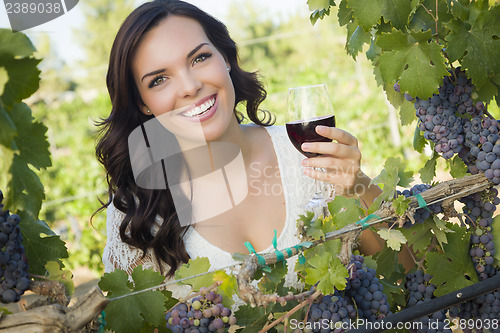 Image of Young Adult Woman Enjoying A Glass of Wine in Vineyard