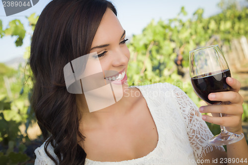 Image of Young Adult Woman Enjoying A Glass of Wine in Vineyard