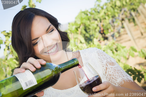 Image of Young Adult Woman Enjoying A Glass of Wine in Vineyard