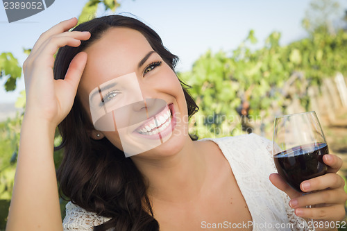 Image of Young Adult Woman Enjoying A Glass of Wine in Vineyard
