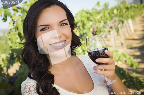 Image of Young Adult Woman Enjoying A Glass of Wine in Vineyard