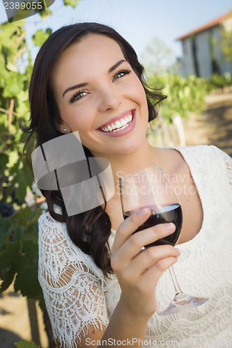 Image of Young Adult Woman Enjoying A Glass of Wine in Vineyard