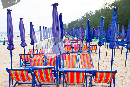 Image of Beach chair and colorful umbrella on the beach. Thailand