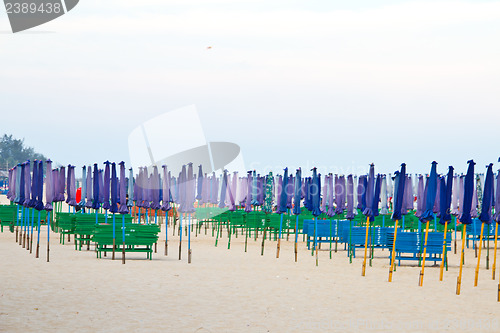Image of Beach chair and colorful umbrella on the beach. Thailand