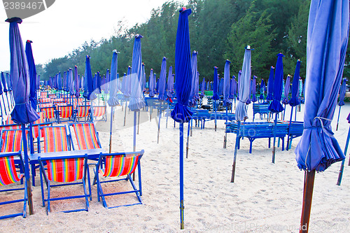 Image of Beach chair and colorful umbrella on the beach. Thailand